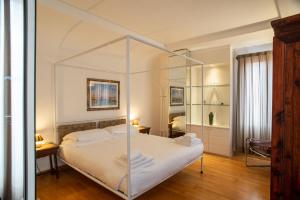 a bedroom with a white bed with a glass canopy at Le Vele di Venezia in Venice
