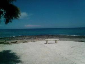 - un banc installé sur la plage près de l'océan dans l'établissement Casa al mare Ostuni camerini, à Villanova di Ostuni