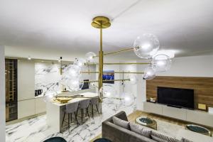 a living room with a large chandelier at Luxury penthouse Marina - Sukošan in Sukošan