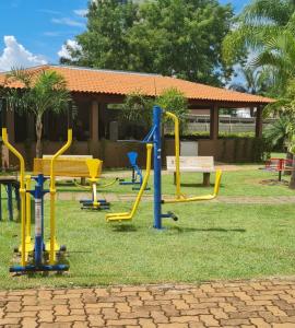 a playground with yellow equipment in a park at Ap confortável prox USP-HC fácil acesso Arena EUROBIKE , estacionamento e wifi 400 mega in Ribeirão Preto