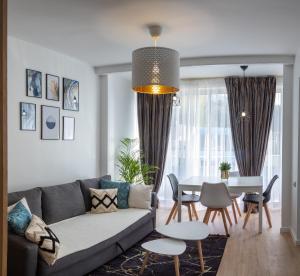 a living room with a couch and a table at Studio Royal - 10 minutes to Monaco in Roquebrune-Cap-Martin