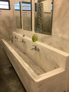 a large marble tub in a bathroom with a mirror at Ode to Joy in Serendah