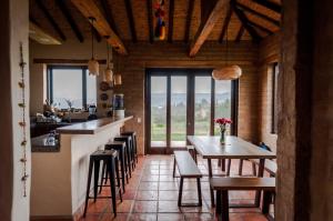 a kitchen and dining room with a table and chairs at ANNAPURNA Villa de Leyva in Villa de Leyva