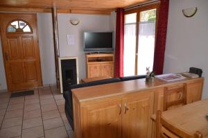 a living room with a couch and a television at le velan in Giez