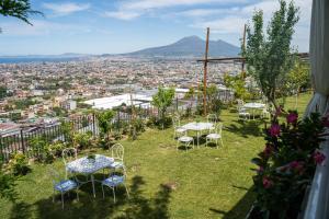 a group of tables and chairs on top of a hill at Villa Palmentiello - Villa con piscina e Vista Golfo di Napoli & Vesuvio in SantʼAntonio Abate