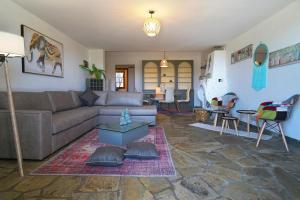 a living room with a couch and a table at Villa Vasiliki in Paralía Avdhíron