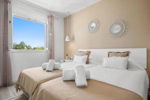 Łóżko lub łóżka w pokoju w obiekcie Apartamento Buganvilla