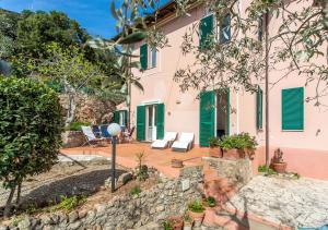 a house with a stone wall and a patio at Casa Alessia in Porto Santo Stefano