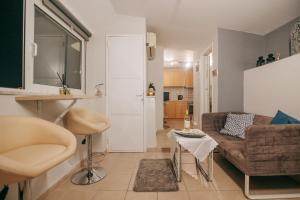 a living room with a couch and a table at Acropoli's balcony in Athens