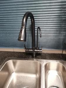 a kitchen sink with a faucet on top of it at Grand Meritus Homestay @Penang in Perai