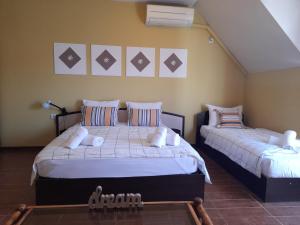 a bedroom with two beds in a room at FOTIADIS BOUTIQUE RООМS and STUDIOS in Veliko Tŭrnovo