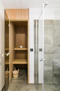 a bathroom with a shower and a glass door at Marissa Resort in Lembruch