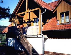 a house with a staircase in front of a house at Daumsmuhle in Mossautal