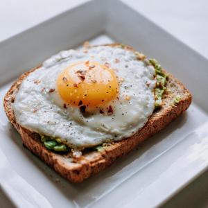 an egg on a piece of bread in a styrofoam box at Hotel Urban Tree in New Delhi