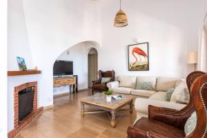 a living room with a couch and a fireplace at Villa Armonia in Son Bou +17 photos