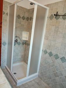 a shower with a glass door in a bathroom at VILLA LUPINO in Orosei +42 photos