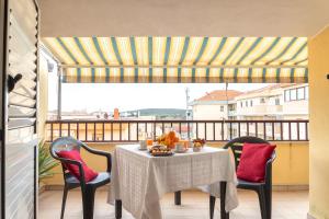 a balcony with a table and chairs and a view at My Baby House in Alghero