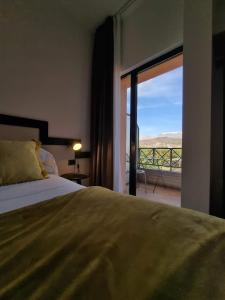 a bedroom with a bed and a window at Hotel Olimpia in Avezzano