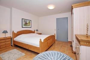 a bedroom with a bed and a table and a desk at La Mer Wohnung 1 in Kühlungsborn