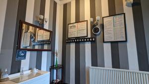 a room with stripes on the wall with a sink at Areawest in Scarborough