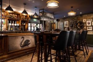 a bar with a swan stencil on the counter at The Black Swan - The Inn Collection Group in Helmsley