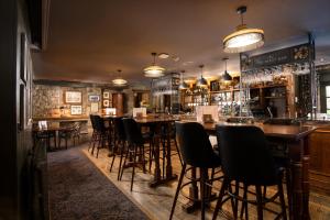 a bar with chairs and tables in a restaurant at The Black Swan - The Inn Collection Group in Helmsley