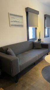 a living room with a gray couch in a room at K Studio in Bodrum City