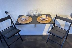 a table with two chairs and two hats on it at K Studio in Bodrum City