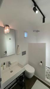 a white bathroom with a toilet and a sink at K Studio in Bodrum City