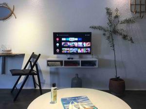 a living room with a table and a tv on a wall at K Studio in Bodrum City