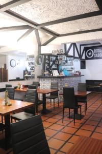 a restaurant with wooden tables and chairs and a counter at Residencial Santo António in Santa Cruz