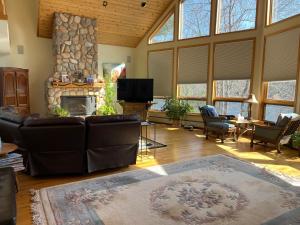 a living room with a couch and a stone fireplace at Amy’s lake house in Traverse City
