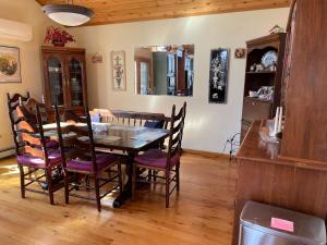 a dining room with a wooden table and chairs at Amy’s lake house in Traverse City