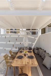 a dining room with a wooden table and chairs at Diadema Villa in Naxos Chora