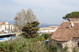 a view of a house with a tile roof at Maison d'Orange - La Pinede in Saint-Tropez
