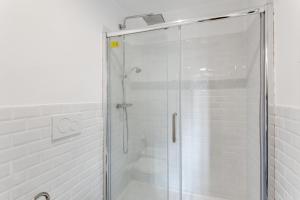a shower with a glass door in a bathroom at Maison d'Orange - La Pinede in Saint-Tropez