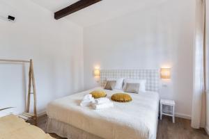 a bedroom with a bed with towels on it at Maison d'Orange - La Pinede in Saint-Tropez
