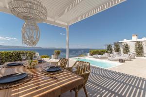 a dining table with a view of the ocean at Diadema Villa in Naxos Chora