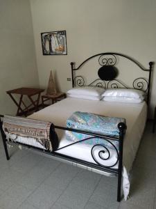 een slaapkamer met een bed met een zwart frame bij mosaicasa in Alfonsine