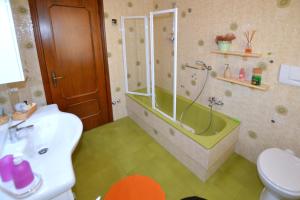 a bathroom with a shower and a tub and a sink at Casa Patty in Sirmione +16 photos