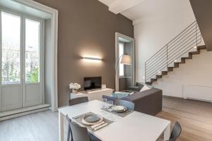 a living room with a white table and a couch at Suite Brunate - by MyHomeInComo in Como