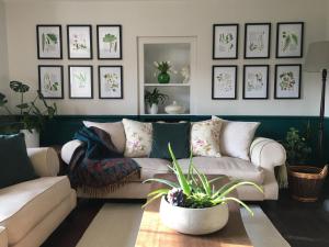 a living room with a couch and a table at Bay Cottage & Bay Stables in Torpoint