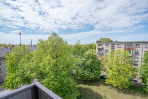 a view from a balcony of trees and buildings at Klaipda Gate Apartments in Klaipėda