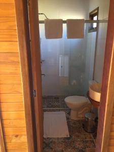 a bathroom with a shower and a toilet and a sink at Pousada Bela Tereza in São Joaquim