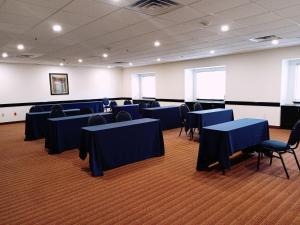 a room with blue tables and chairs in it at Microtel Inn and Suites by Wyndham Toluca in Toluca