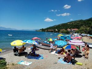 een groep mensen op een strand met parasols bij Studia Daniel in Ohrid