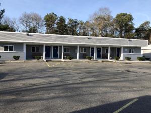 an empty parking lot in front of a building at Rosewood Motel in East Wareham