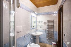 a bathroom with a sink and a toilet and a mirror at Residenza I Gioielli in Tropea