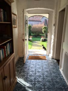 a hallway with an open door with a dog looking out at Bay Cottage & Bay Stables in Torpoint