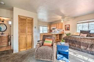 a bedroom with a bed and a chair and a kitchen at Romantic Treetop Studio 30 Mi to Yosemite! in Coarsegold